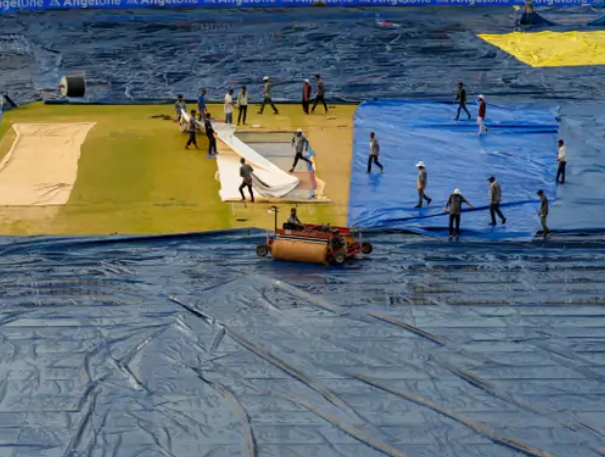 Toss delayed due to wet ground, inspection scheduled for 8:15 am